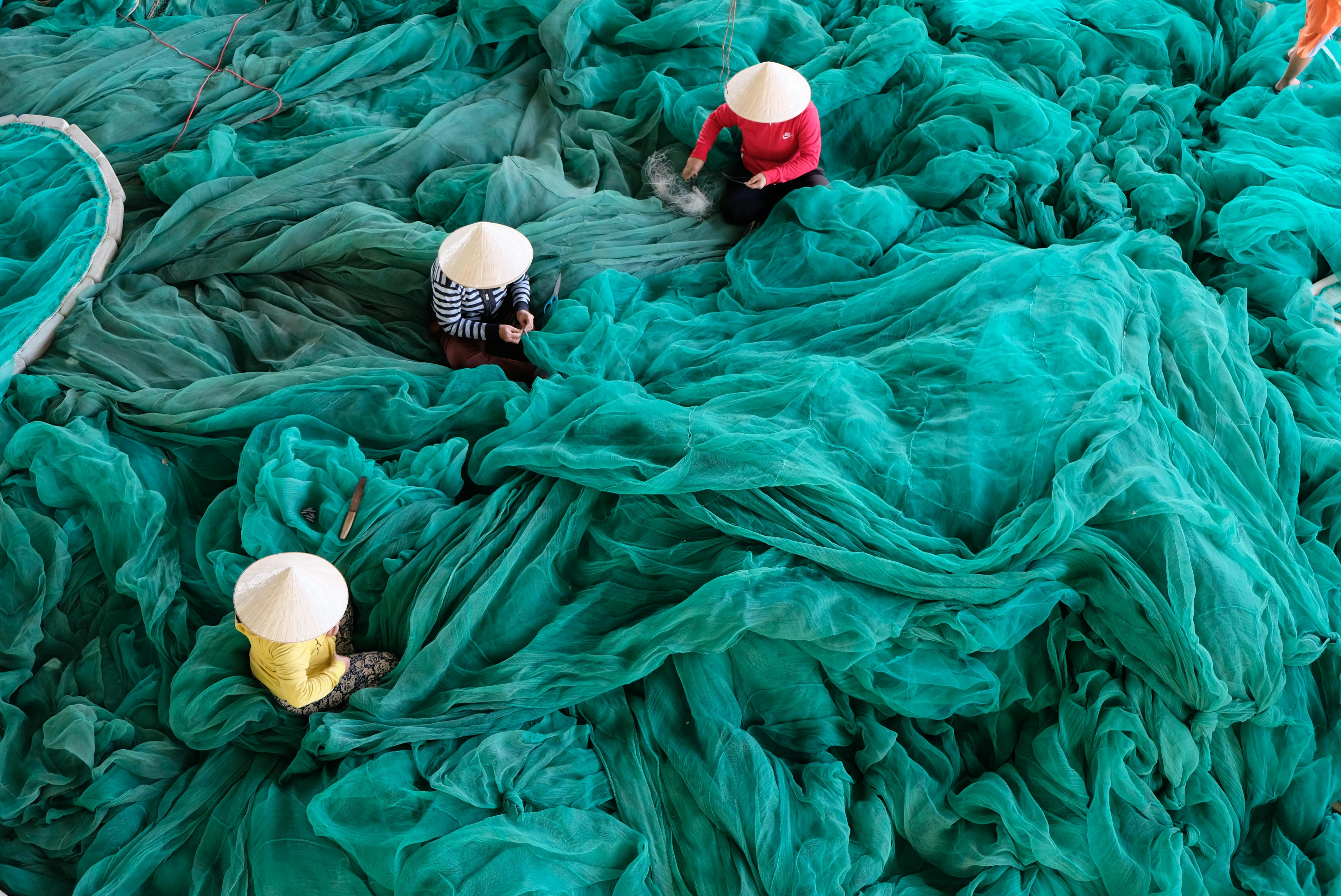 Photo by Gin Patin: https://www.pexels.com/photo/three-person-sitting-on-green-large-net-2692556/